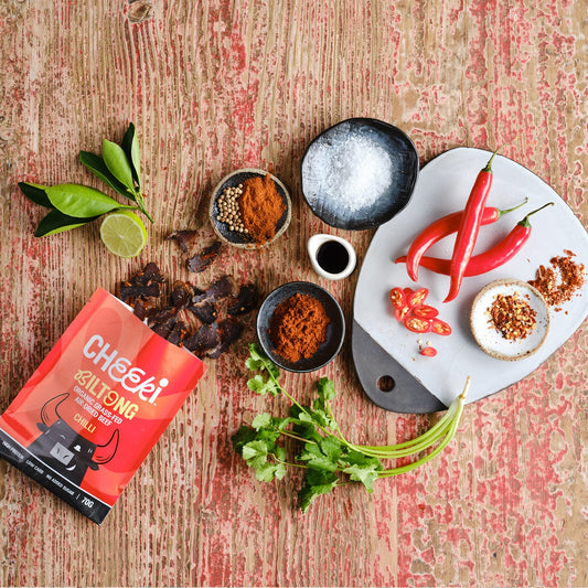 Cheeki Chilli Biltong slices on canvas background showing premium texture and spice